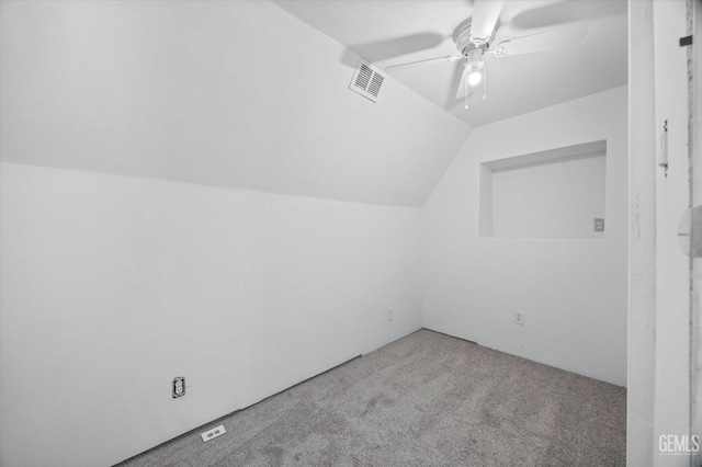 additional living space with lofted ceiling, ceiling fan, visible vents, and carpet flooring