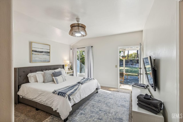 carpeted bedroom featuring lofted ceiling, access to outside, and multiple windows