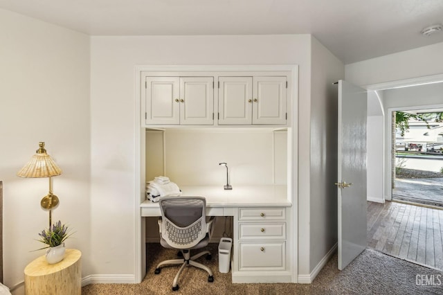 office space with carpet and built in desk