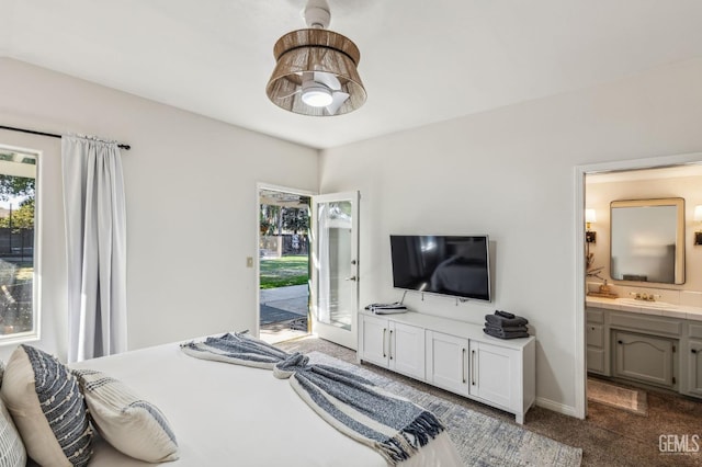 carpeted bedroom with access to outside, ensuite bathroom, sink, and ceiling fan