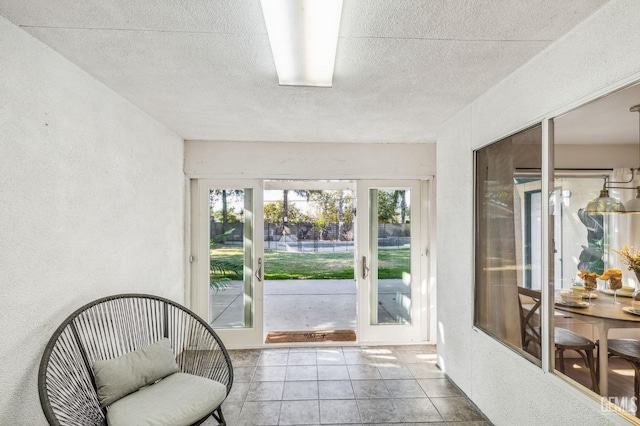 sunroom / solarium featuring french doors