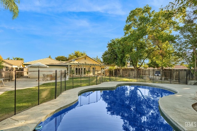 view of swimming pool with a yard and a patio