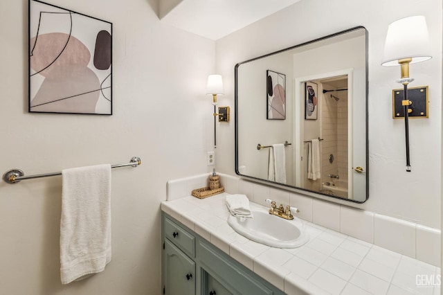 bathroom featuring backsplash, vanity, and washtub / shower combination