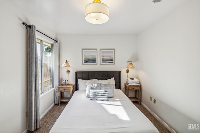 bedroom featuring dark carpet