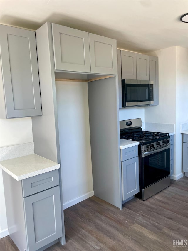 656 Minter Ave, Shafter, CA 93263 - kitchen featuring stainless steel appliances, gray cabinets, dark wood finished floors, and light countertops