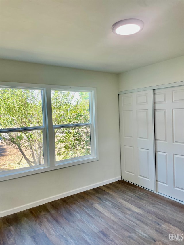 656 Minter Ave, Shafter, CA 93263 - unfurnished bedroom featuring dark wood-type flooring and a closet