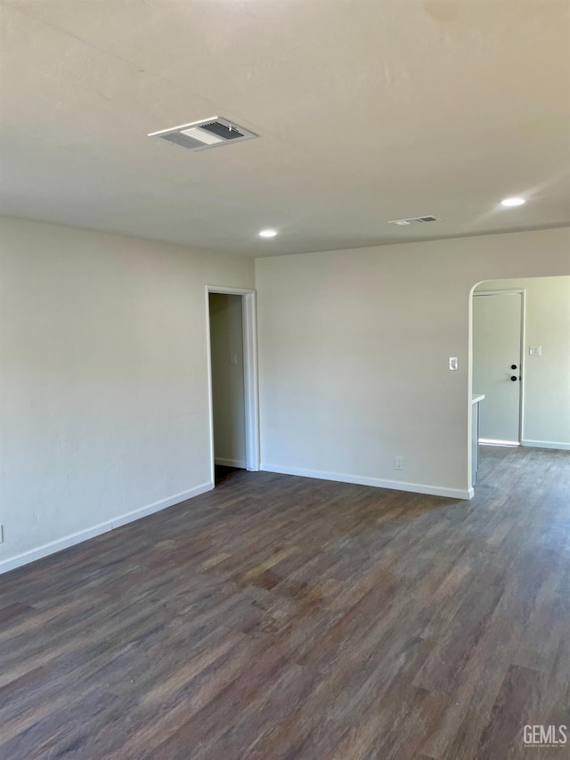 656 Minter Ave, Shafter, CA 93263 - spare room with dark wood-type flooring, arched walkways, and recessed lighting