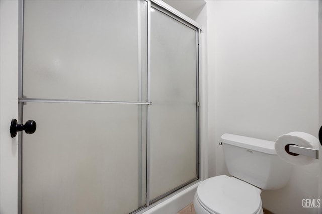 bathroom with toilet and an enclosed shower