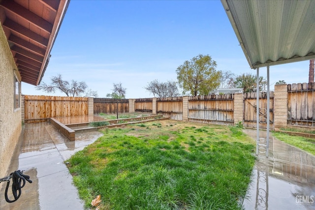 view of yard with a garden and a fenced backyard