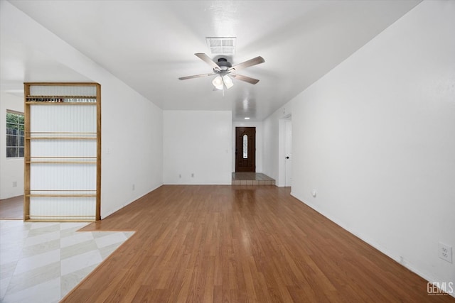 unfurnished living room featuring ceiling fan, wood finished floors, and visible vents