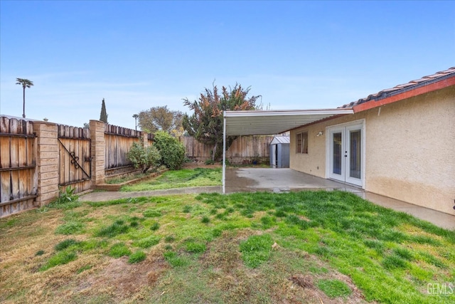 view of yard with a patio, french doors, and a fenced backyard