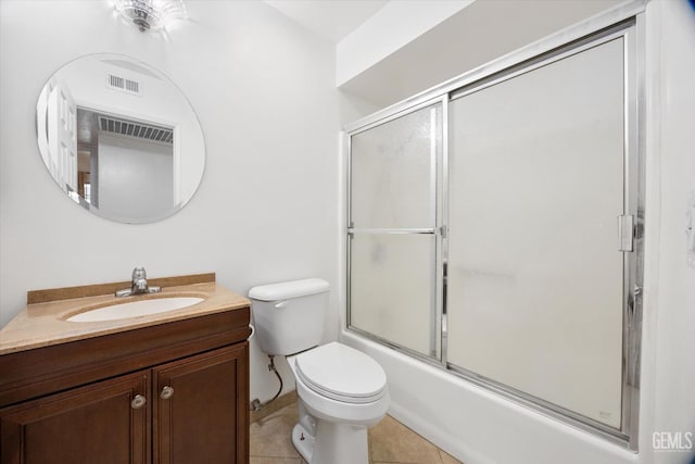 full bath with bath / shower combo with glass door, visible vents, toilet, vanity, and tile patterned floors