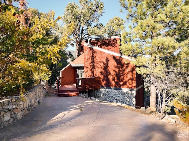 view of property exterior with a deck