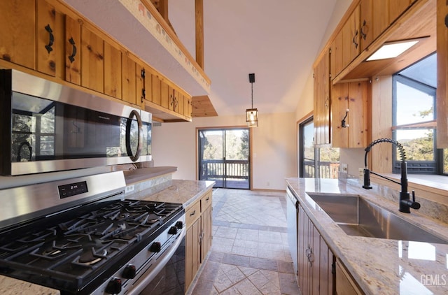 kitchen with sink, hanging light fixtures, stainless steel appliances, light stone counters, and vaulted ceiling