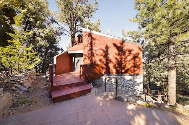 rear view of property with a wooden deck