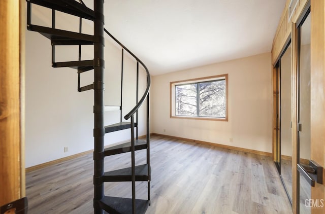 stairway featuring wood-type flooring