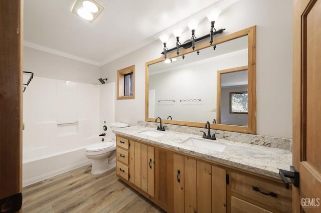 full bathroom with ornamental molding, vanity, shower / tub combination, hardwood / wood-style floors, and toilet