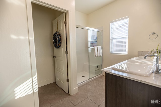 bathroom with vanity, tile patterned floors, and a shower with door