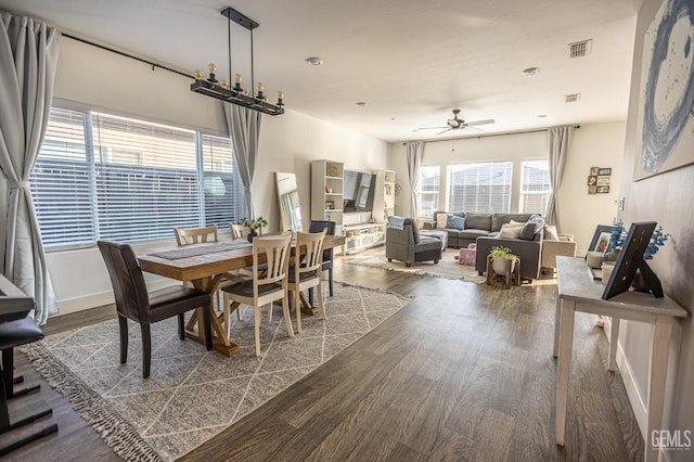 dining space with ceiling fan and dark hardwood / wood-style floors