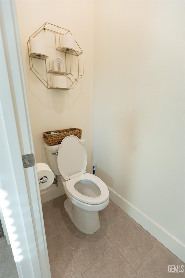 bathroom with toilet and tile patterned floors