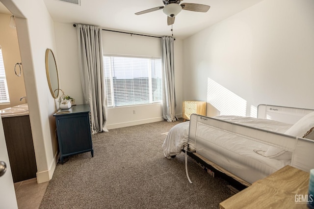 bedroom featuring ceiling fan and carpet