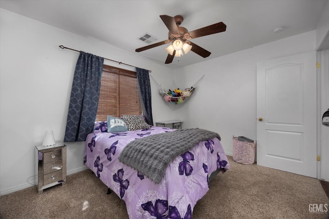 carpeted bedroom with visible vents, baseboards, and ceiling fan