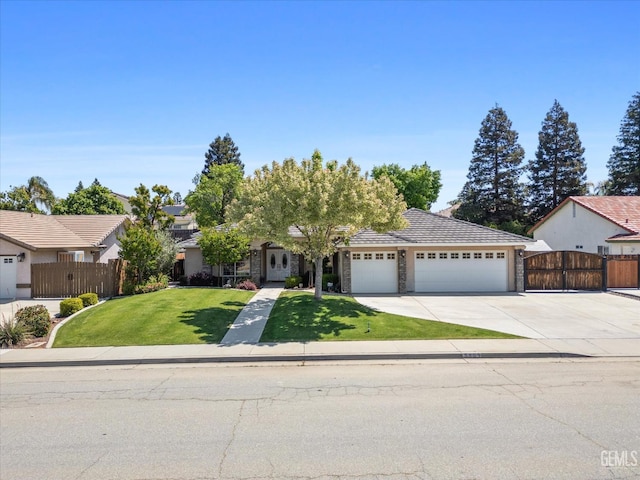 view of property hidden behind natural elements featuring fence, a front lawn, a garage, a gate, and driveway