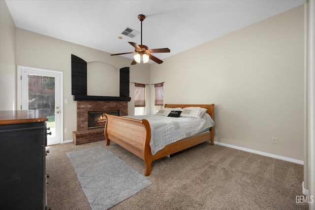 bedroom with baseboards, a fireplace, light colored carpet, and visible vents