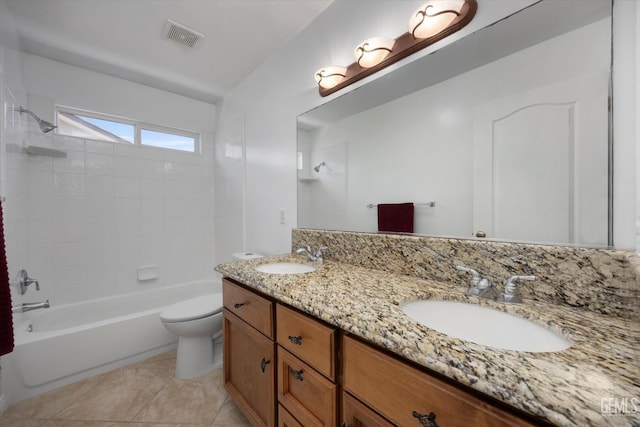 bathroom with toilet, visible vents, bathing tub / shower combination, and a sink