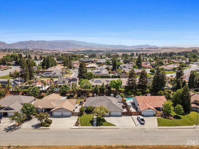 birds eye view of property with a mountain view and a residential view