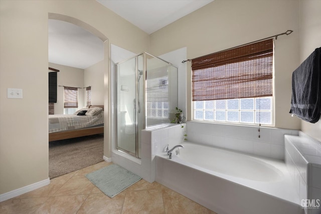 full bath featuring baseboards, connected bathroom, a bath, tile patterned floors, and a stall shower