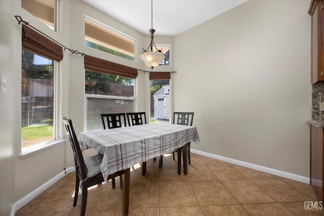 dining space with baseboards and light tile patterned floors