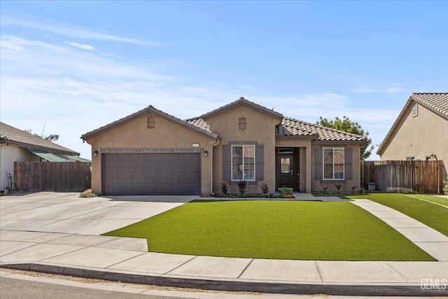 mediterranean / spanish-style house with a front yard and a garage