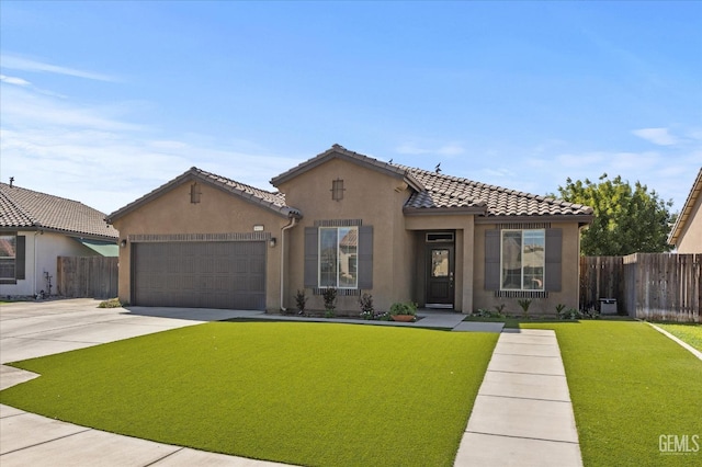 mediterranean / spanish-style home featuring a front lawn and a garage