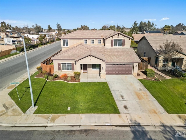 view of front of house featuring a garage and a front lawn