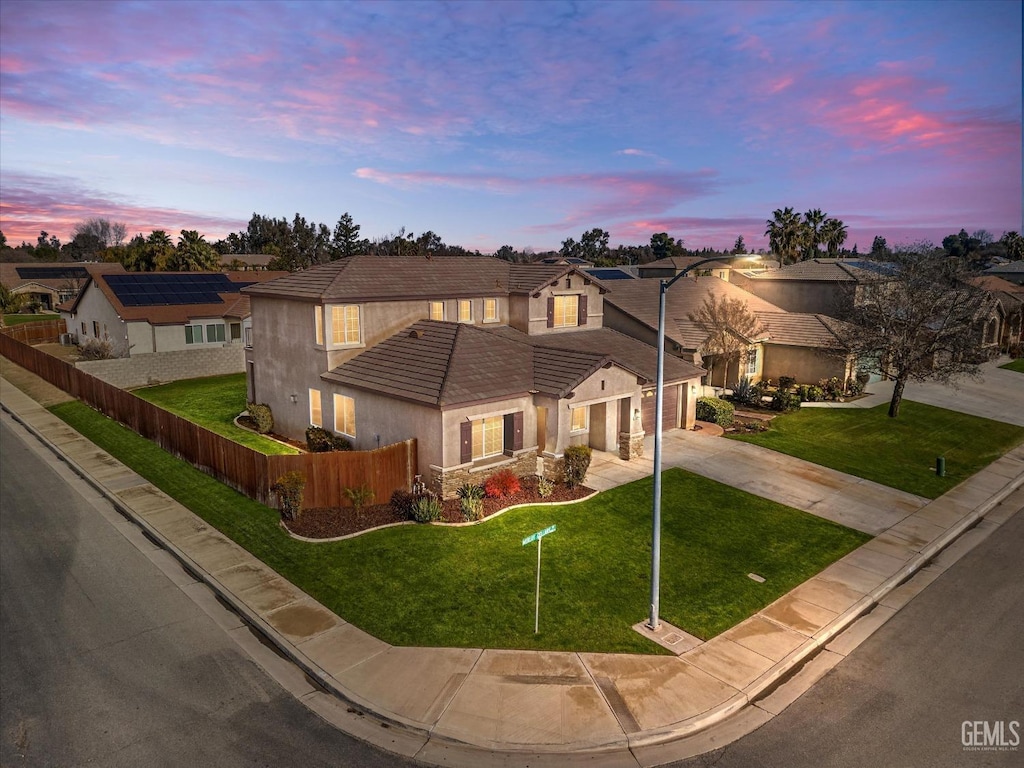 view of front of house featuring a yard and a garage