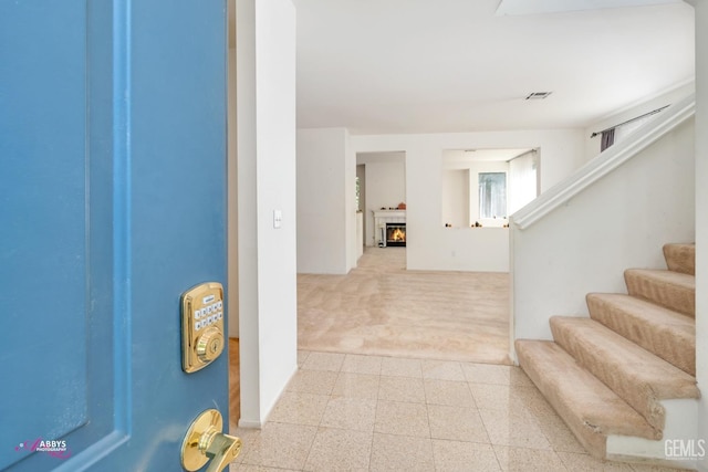 corridor with light colored carpet