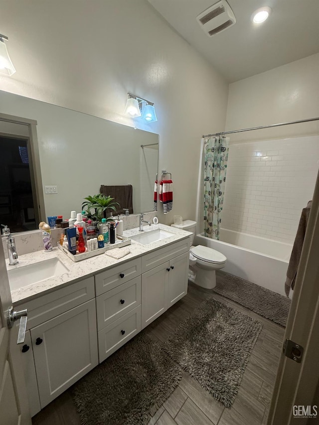 5917 Hawthorn Tree Ln, Bakersfield, CA 93313 - bathroom with toilet, double vanity, shower / bath combo with shower curtain, and wood finished floors