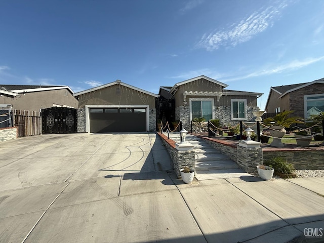 5917 Hawthorn Tree Ln, Bakersfield, CA 93313 - ranch-style home with driveway, an attached garage, and stone siding