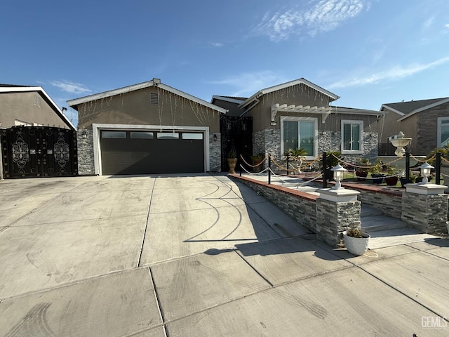 5917 Hawthorn Tree Ln, Bakersfield, CA 93313 - ranch-style house featuring driveway, stone siding, and a garage