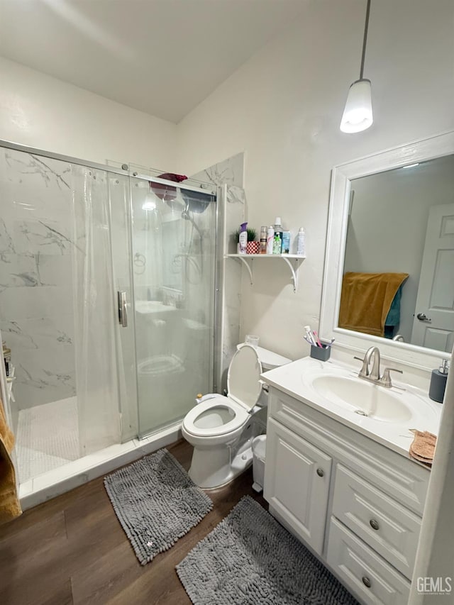 5917 Hawthorn Tree Ln, Bakersfield, CA 93313 - full bathroom with vanity, toilet, a marble finish shower, and wood finished floors