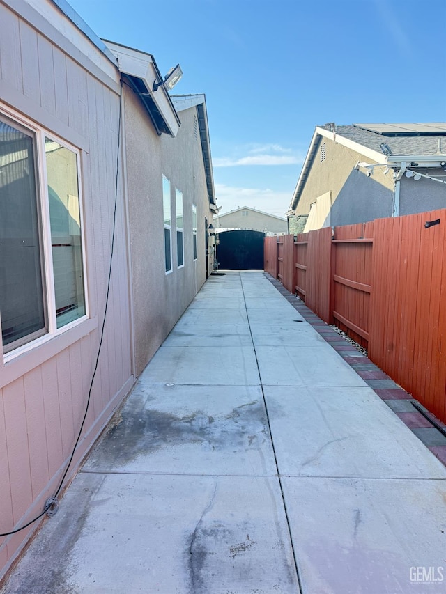 5917 Hawthorn Tree Ln, Bakersfield, CA 93313 - view of side of home featuring a fenced backyard, a patio, and stucco siding