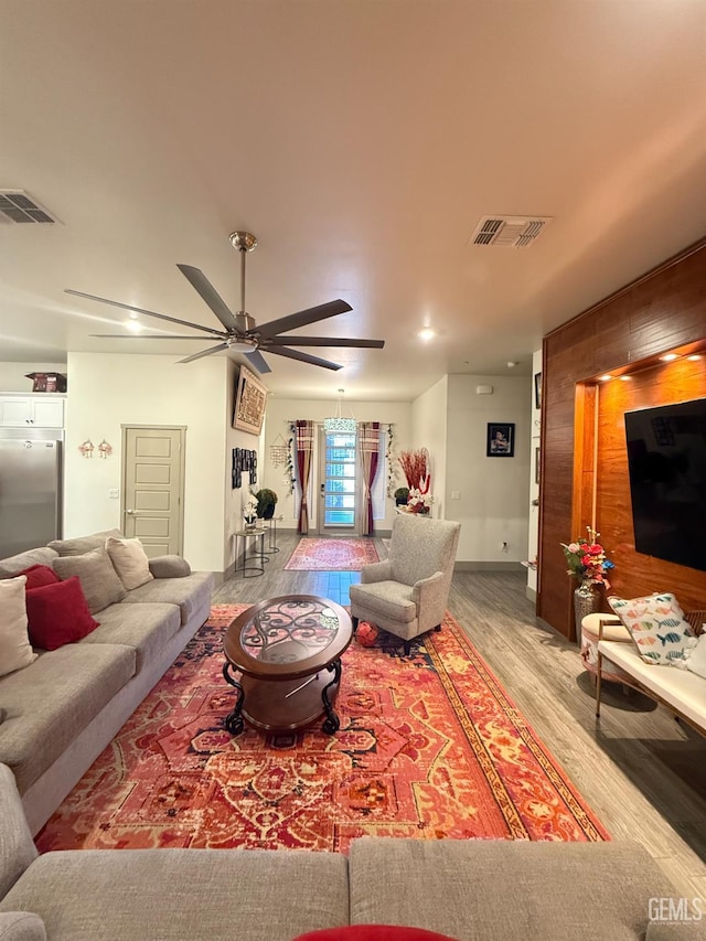 5917 Hawthorn Tree Ln, Bakersfield, CA 93313 - living room featuring wood finished floors, ceiling fan, and wooden walls