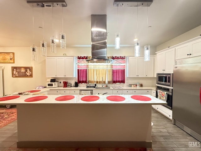 5917 Hawthorn Tree Ln, Bakersfield, CA 93313 - kitchen featuring built in appliances, island exhaust hood, a kitchen island, and white cabinets