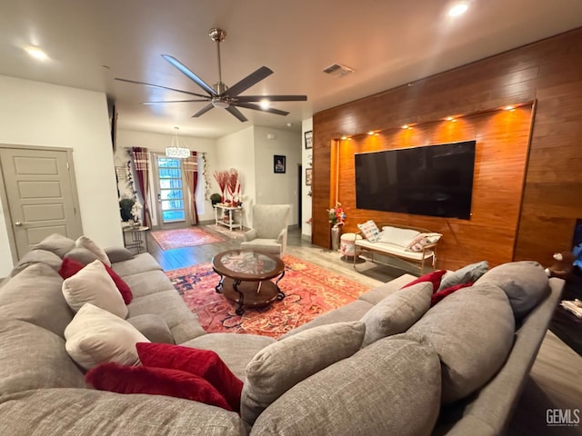 5917 Hawthorn Tree Ln, Bakersfield, CA 93313 - living room featuring wood finished floors, a ceiling fan, wooden walls, an accent wall, and recessed lighting