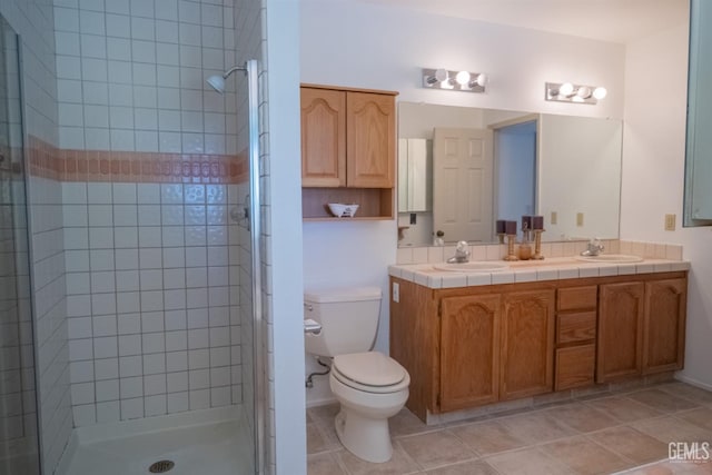 bathroom featuring vanity, toilet, and walk in shower