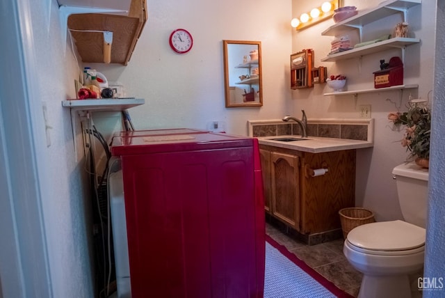 interior space with tile patterned floors, vanity, and toilet