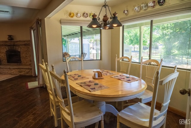 dining room with a notable chandelier and dark hardwood / wood-style floors