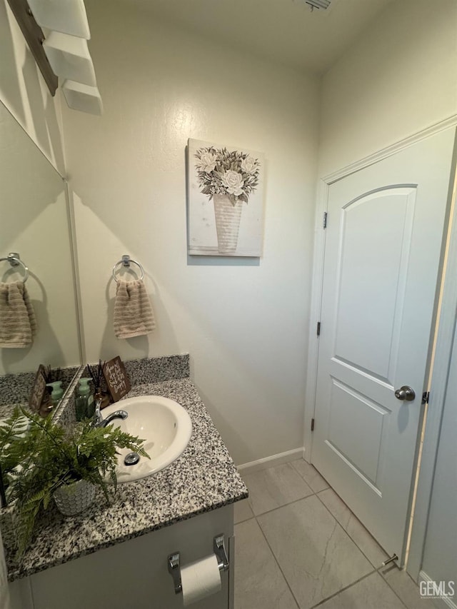 bathroom featuring baseboards and vanity