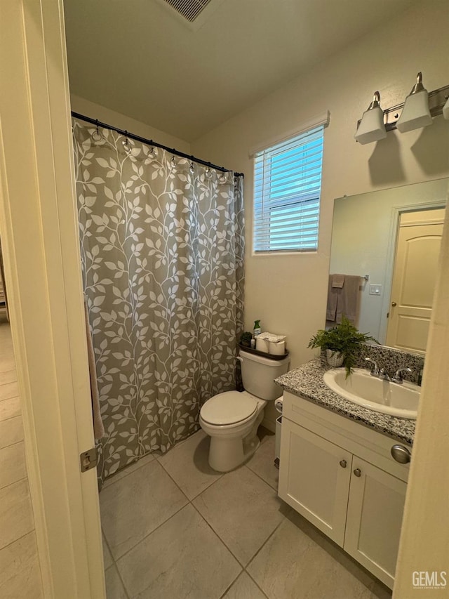 full bathroom featuring curtained shower, visible vents, toilet, vanity, and tile patterned flooring